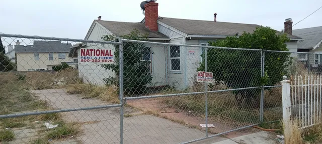 a front view of a house with iron fence