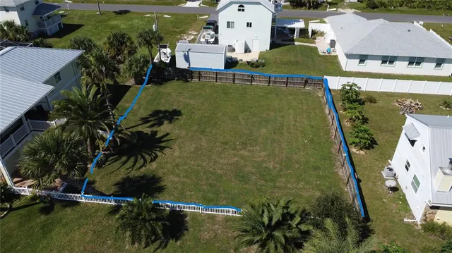 an aerial view of residential houses with outdoor space and swimming pool