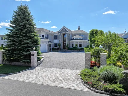 a front view of a house with a yard and a garage