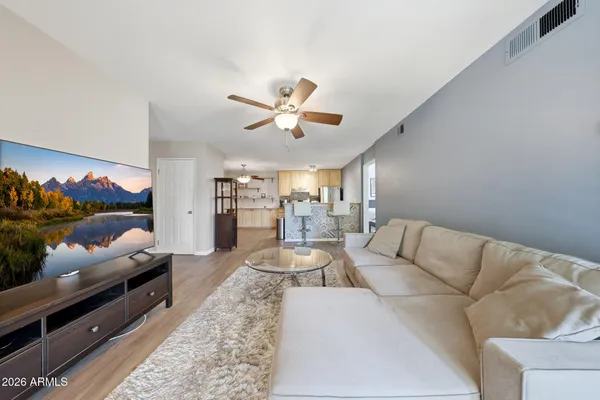 a living room with furniture a rug and a chandelier