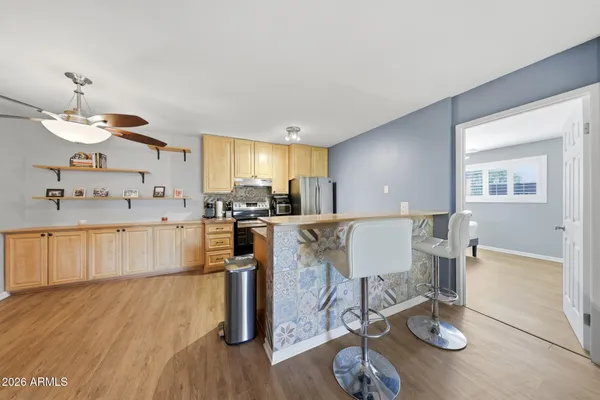 a living room with kitchen island furniture and a wooden floor
