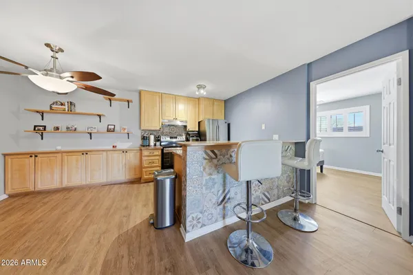 a living room with kitchen island furniture and a wooden floor