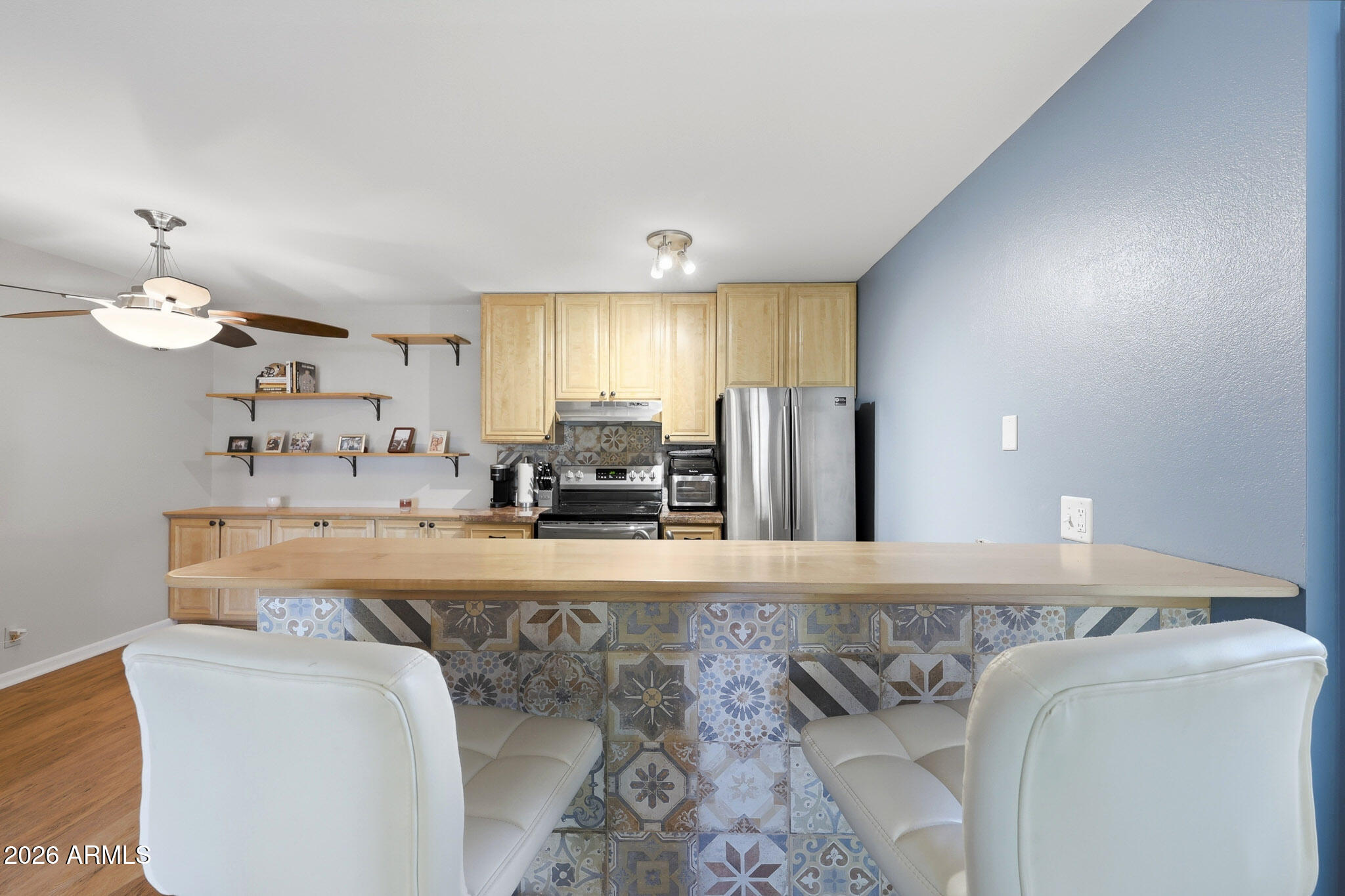 5525 East Thomas Road, Unit R 16 Phoenix, AZ 85018 - Photo 16 of 27 a large kitchen with kitchen island a sink stainless steel appliances and cabinets