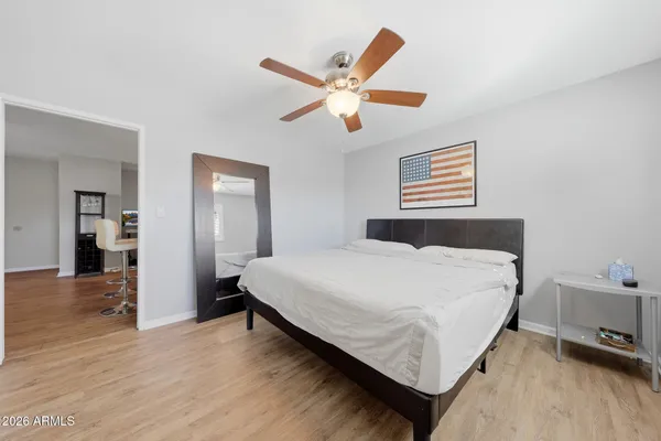 a bedroom with a bed and a ceiling fan