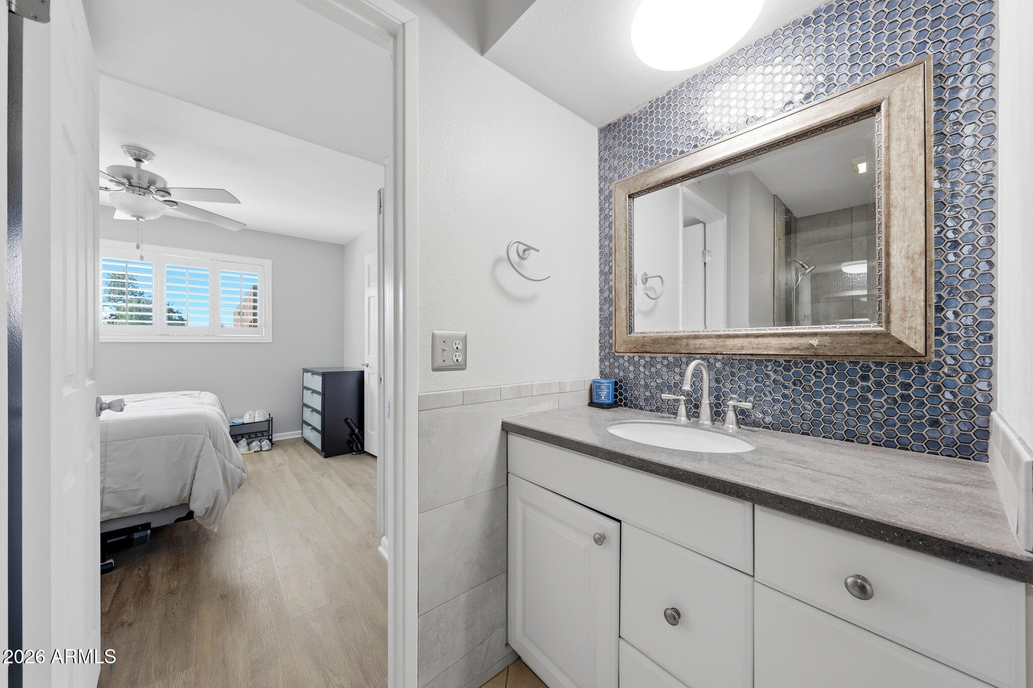 5525 East Thomas Road, Unit R 16 Phoenix, AZ 85018 - Photo 20 of 27 a en suite bathroom with a granite countertop tub and a mirror