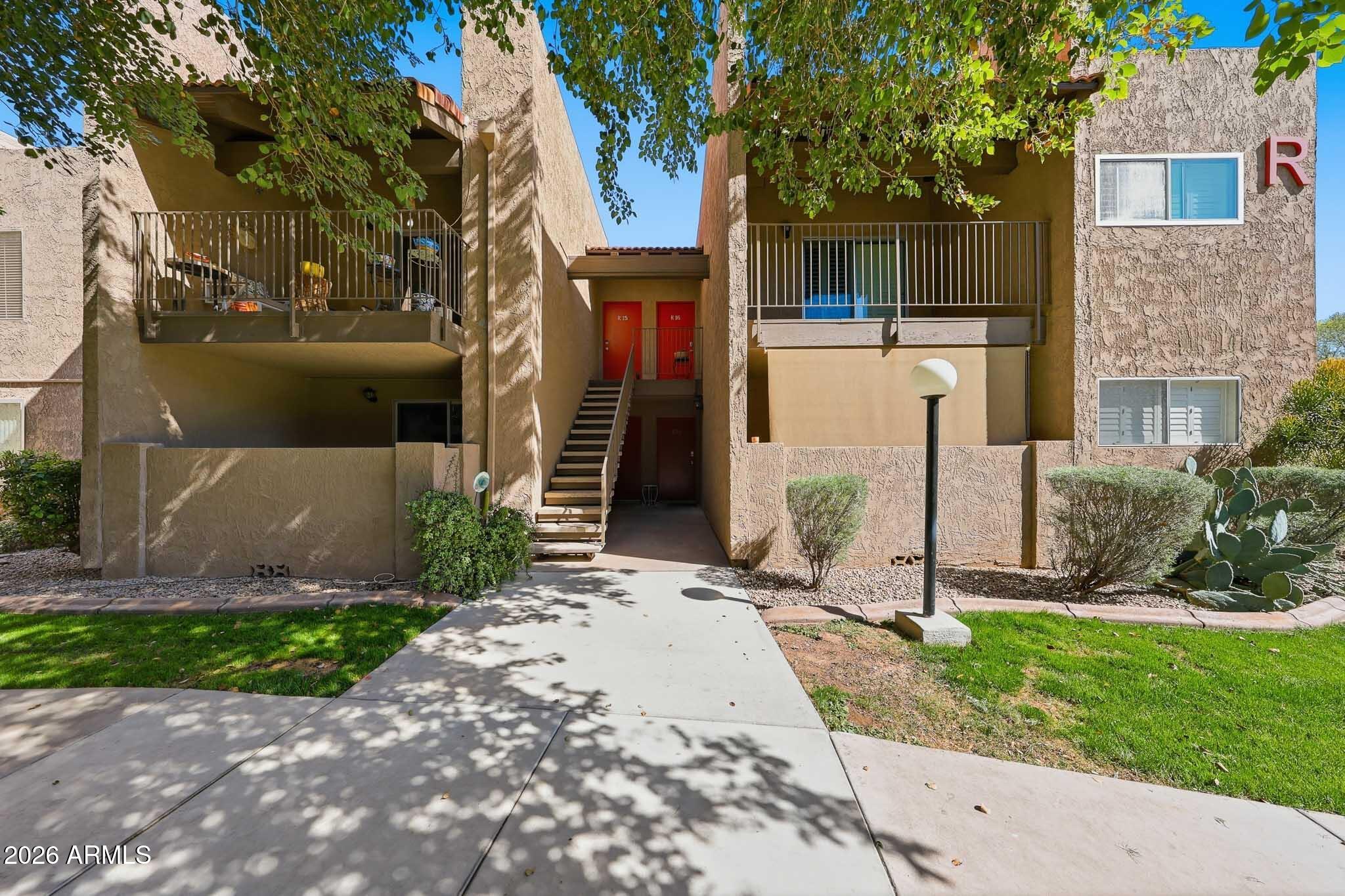 5525 East Thomas Road, Unit R 16 Phoenix, AZ 85018 - Photo 2 of 27 a front view of a house with a yard