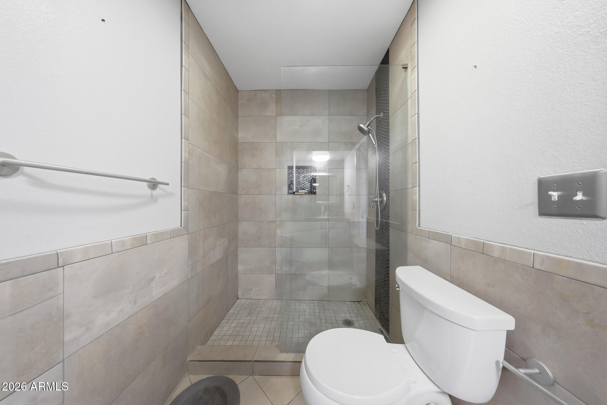 5525 East Thomas Road, Unit R 16 Phoenix, AZ 85018 - Photo 21 of 27 a white toilet sitting next to a shower