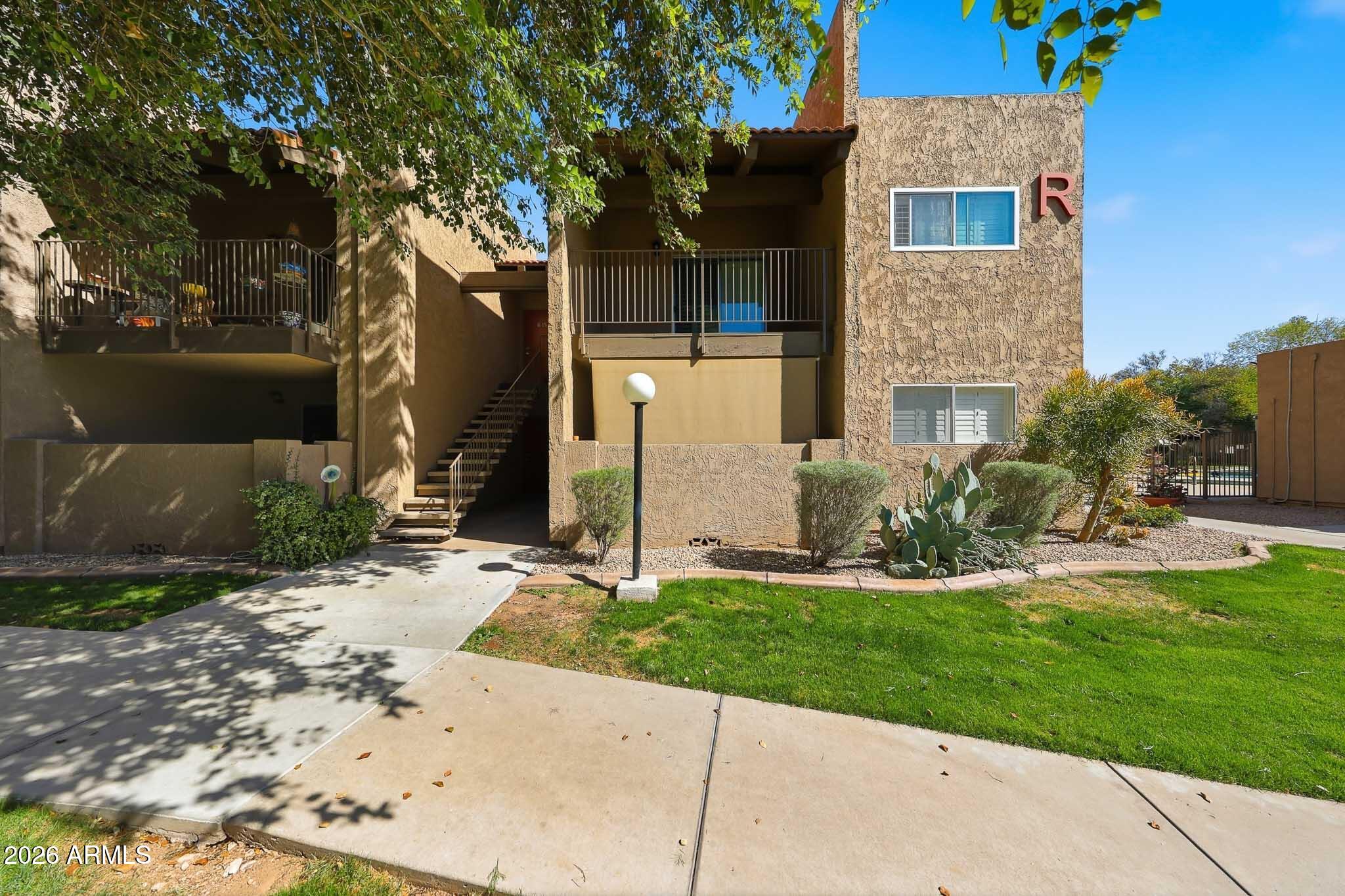 5525 East Thomas Road, Unit R 16 Phoenix, AZ 85018 - Photo 3 of 27 a front view of a house with a yard