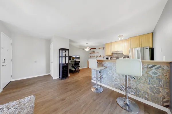 a living room with furniture and a wooden floor