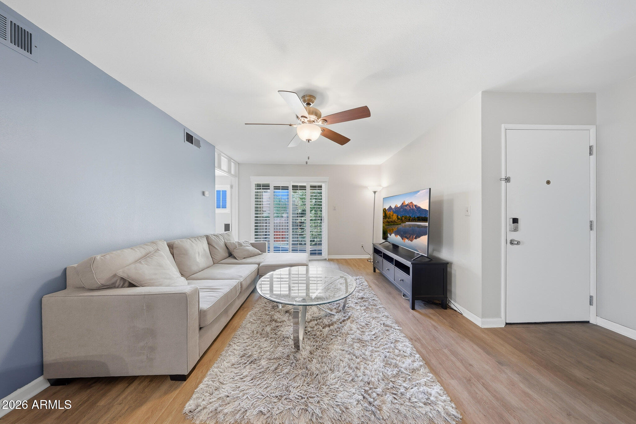 5525 East Thomas Road, Unit R 16 Phoenix, AZ 85018 - Photo 7 of 27 a living room with furniture and a flat screen tv