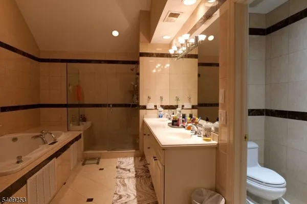 a bathroom with a sink vanity mirror and toilet