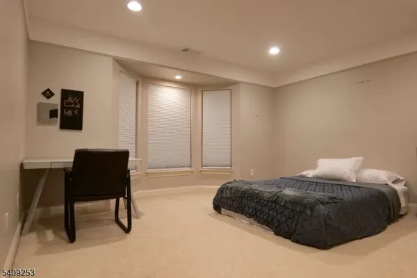 a bedroom with a bed and a chair