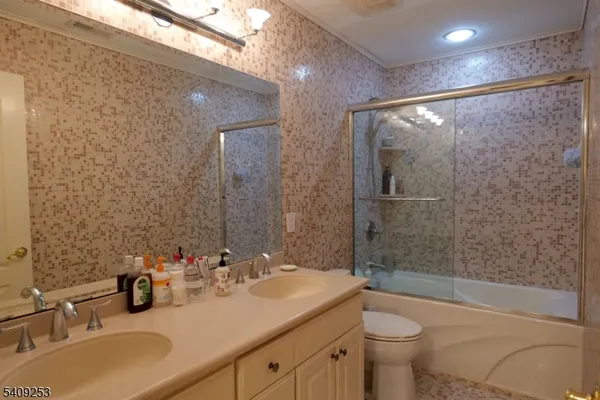 a bathroom with a sink mirror toilet and bathtub