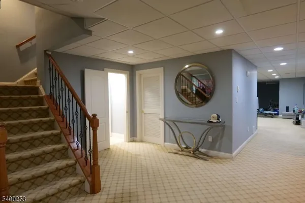 a view of a livingroom with a furniture and a mirror