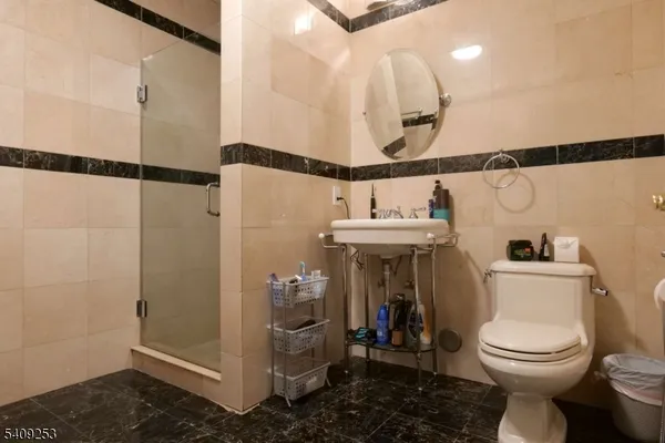 a bathroom with a toilet and a shower