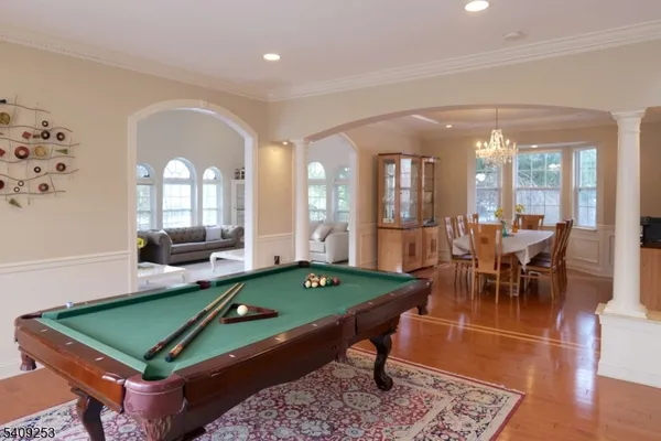 a room with pool table and windows