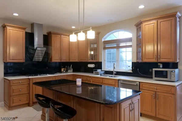 a kitchen with a sink a counter space appliances and cabinets