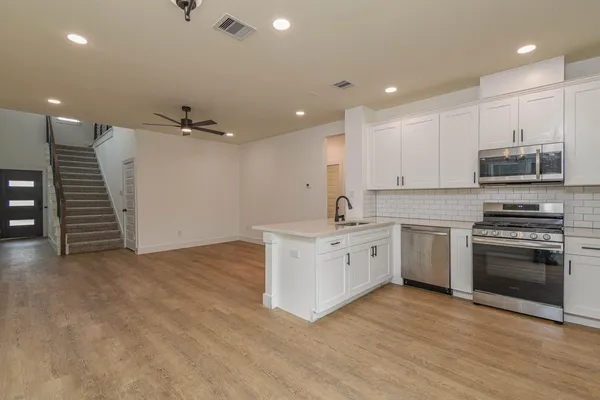 a kitchen with a stove and a sink