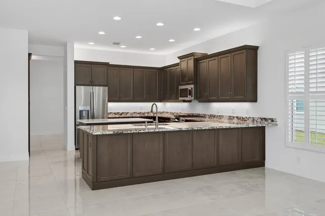 a large white kitchen with a large window