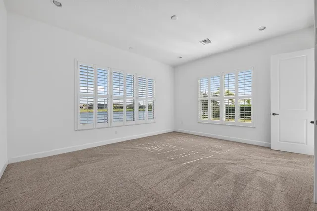 a bathroom with a granite countertop sink a toilet a mirror and shower