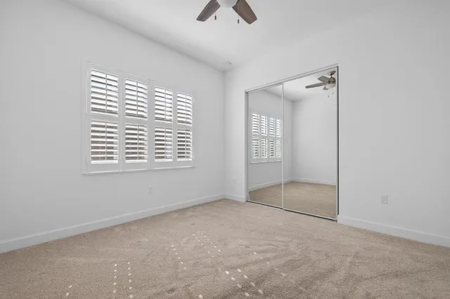 a bathroom with a granite countertop bathtub shower sink vanity and toilet