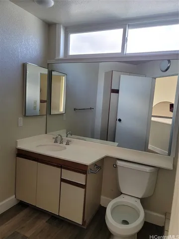 a bathroom with a toilet a sink and a mirror