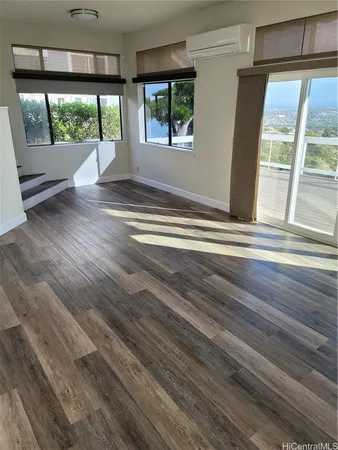 a view of a room with wooden floor and staircase