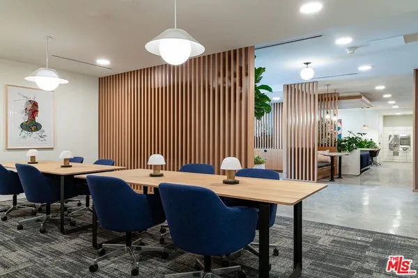 a view of a a dining room with furniture window and wooden floor