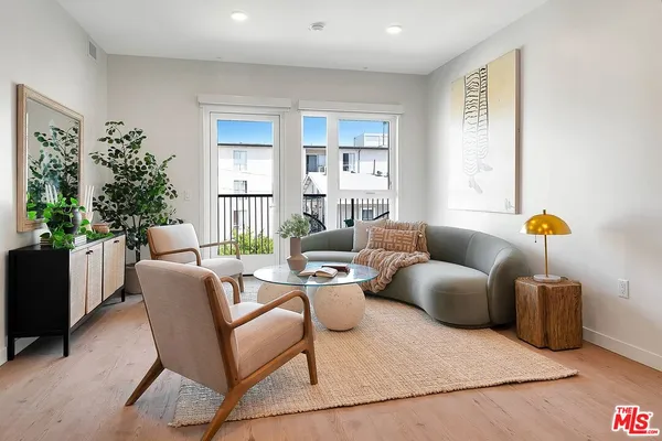 a living room with furniture and flowers