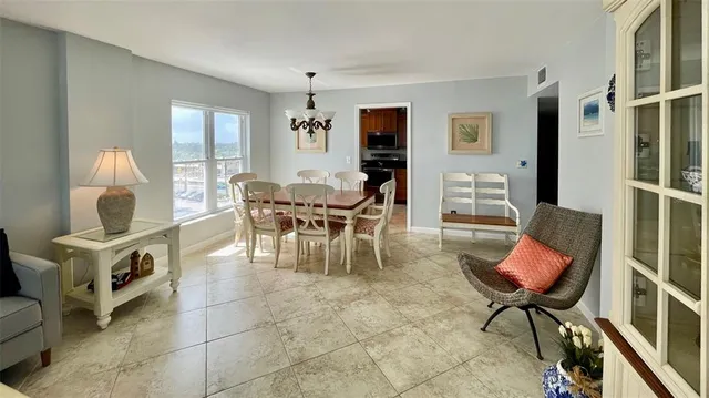 a living room with furniture a chandelier and a window