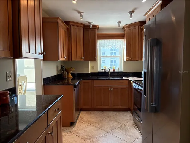 a kitchen with stainless steel appliances granite countertop a stove and a refrigerator