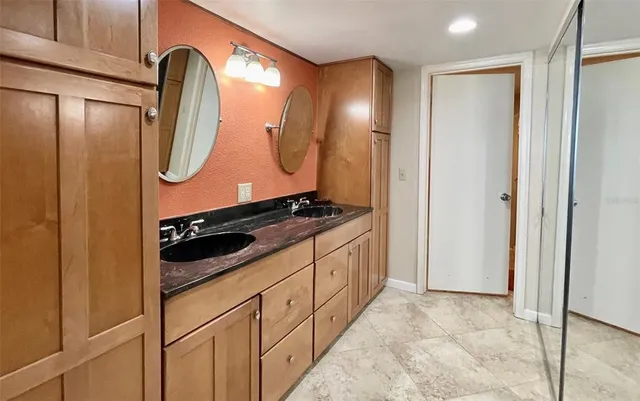 a bathroom with a double vanity sink and a mirror