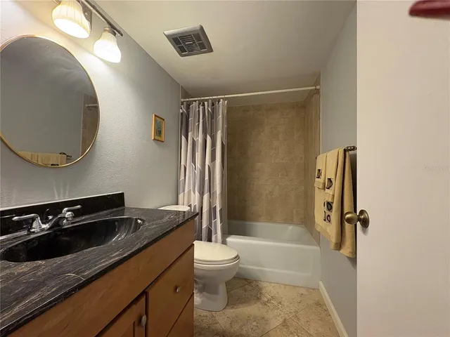 a view of a balcony with chair and wooden floor