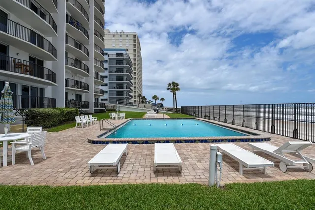 a view of a swimming pool with a lounge chairs