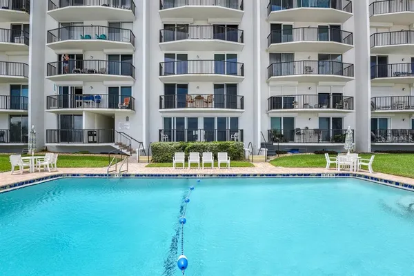 a view of a house with a yard and sitting area
