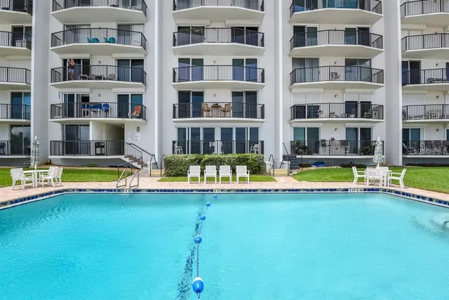 a view of a house with a yard and sitting area