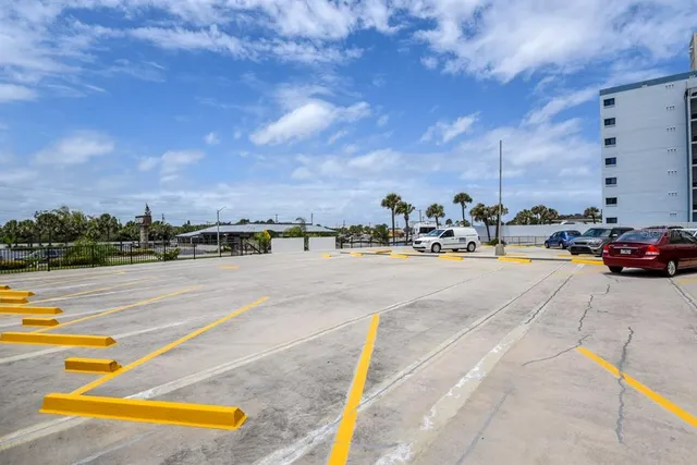 a sign board with buildings in the background