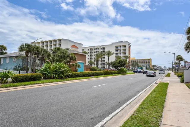 a backyard of a house with a yard and outdoor seating