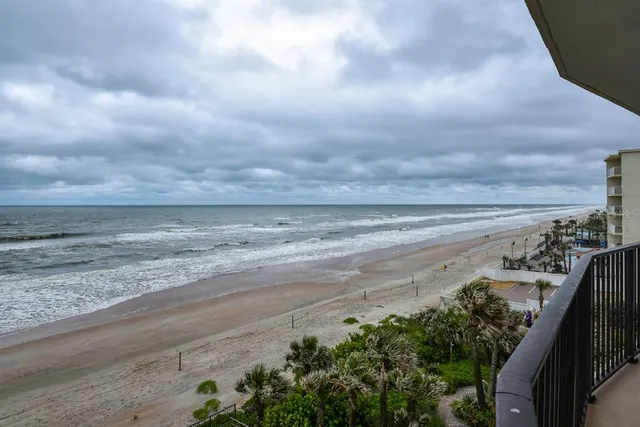 a lobby with furniture and potted plants