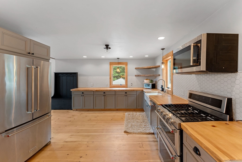22 Potter Road Douglas, MA 01516 - Photo 12 of 40 a kitchen with stainless steel appliances granite countertop a stove a refrigerator and a microwave