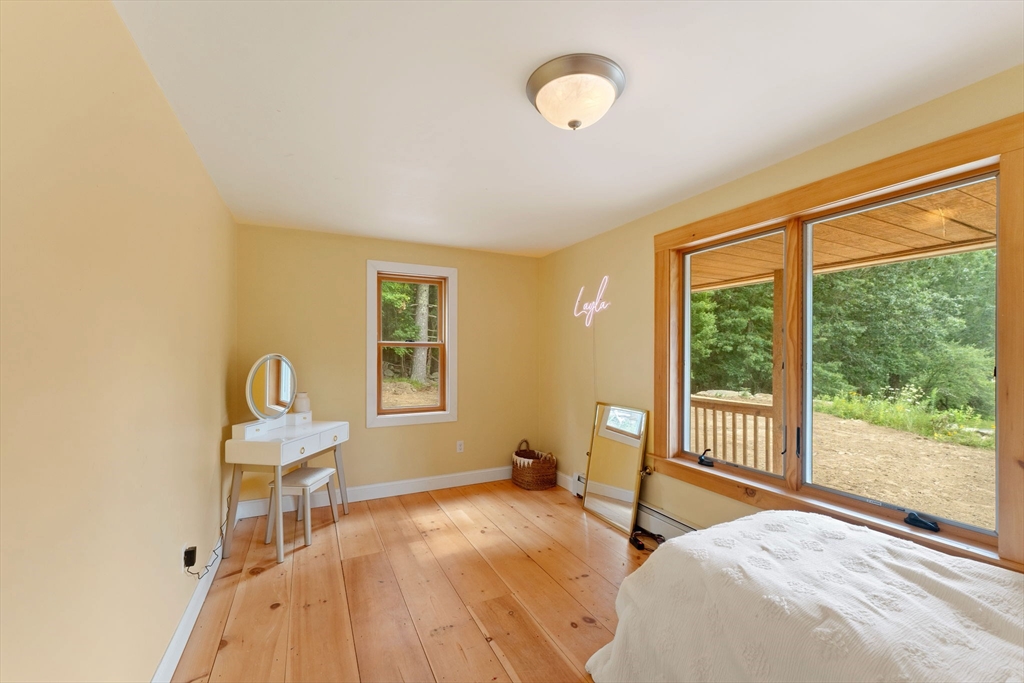 22 Potter Road Douglas, MA 01516 - Photo 20 of 40 a bedroom with a bed and wooden floor