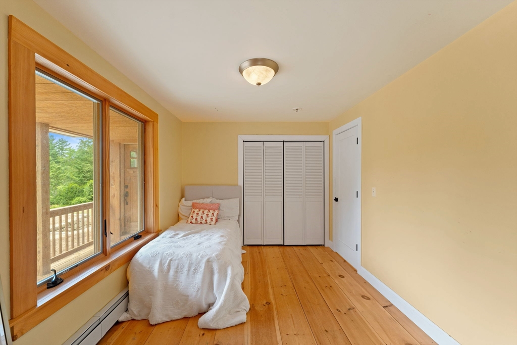 22 Potter Road Douglas, MA 01516 - Photo 21 of 40 a spacious bedroom with a bed and wooden floor