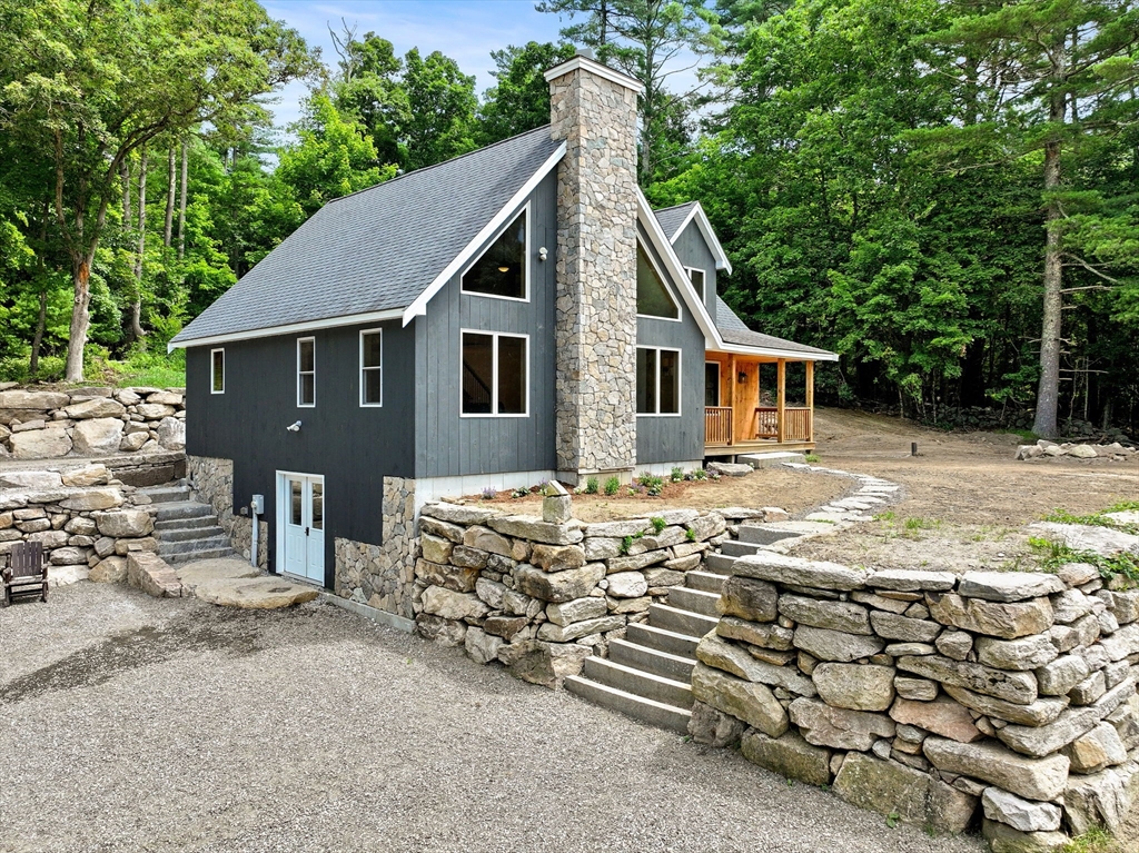 22 Potter Road Douglas, MA 01516 - Photo 35 of 40 a view of a house with a yard and lawn chairs