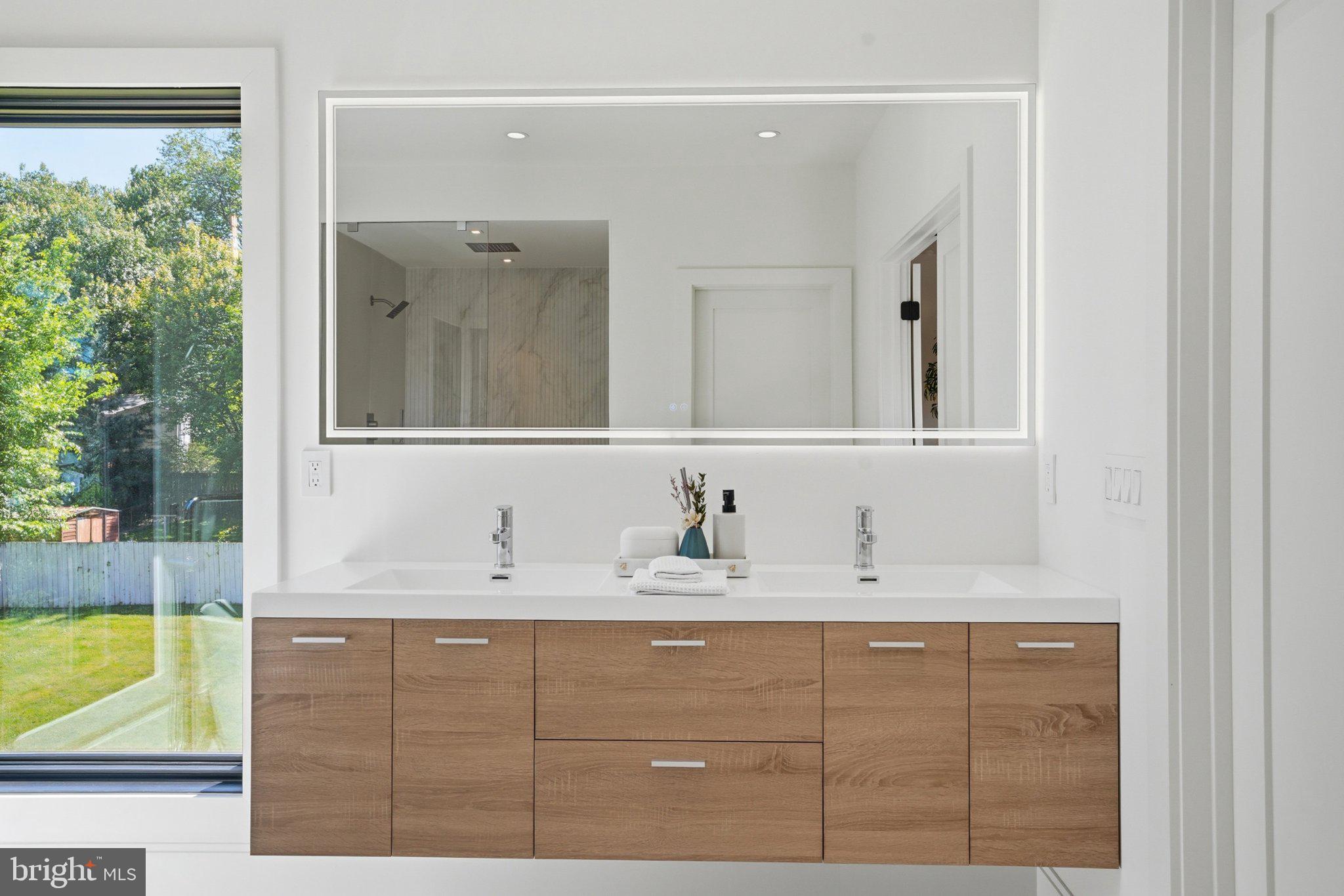 7421 Magarity Road Falls Church, VA 22043 - Photo 53 of 66 Sleek modern bathroom with natural light.