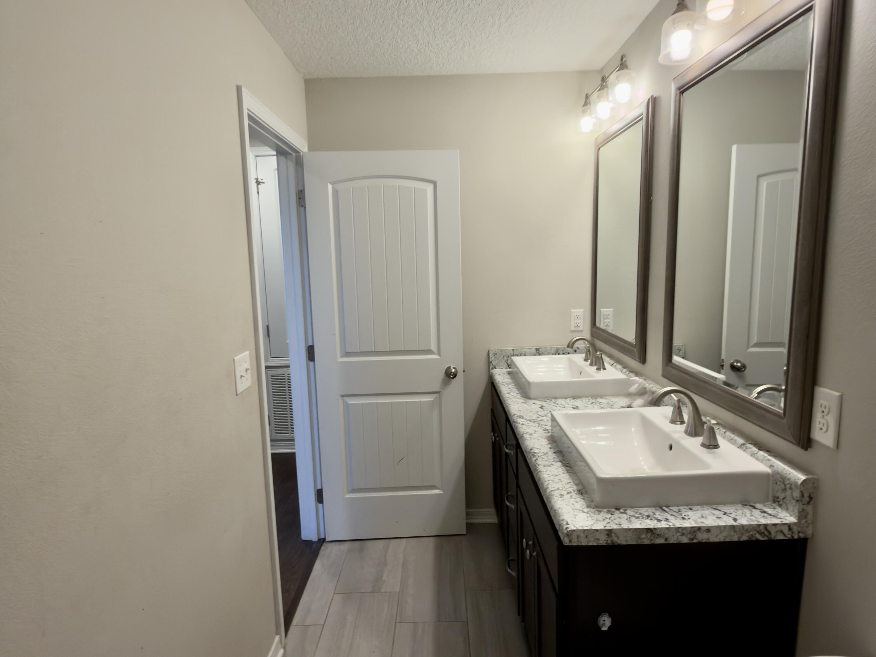 201 Wainwright Drive Crestview, FL 32539 - Photo 17 of 26 a bathroom with a granite countertop sink and a mirror