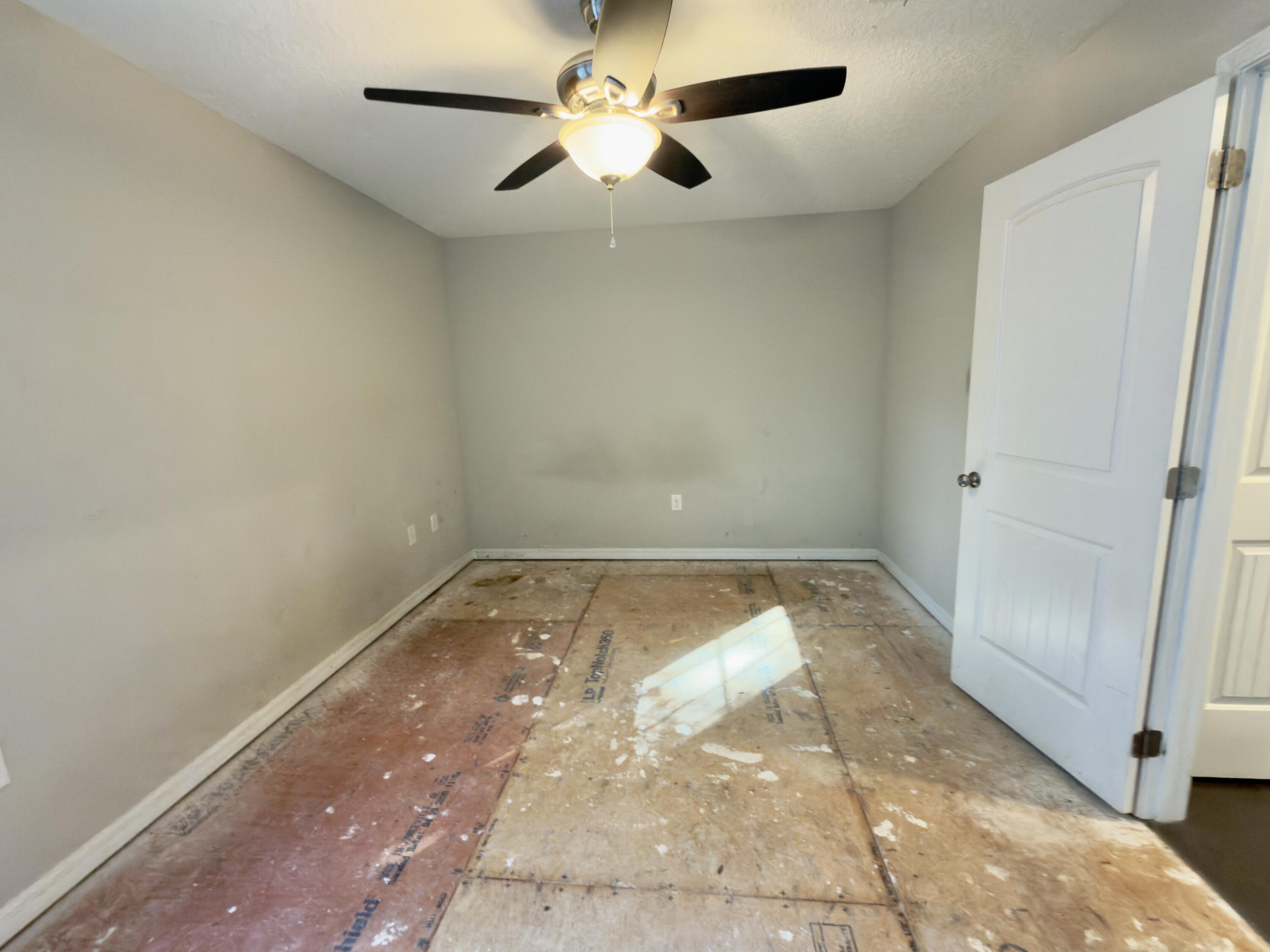 201 Wainwright Drive Crestview, FL 32539 - Photo 20 of 26 en empty room with wooden floor and fan