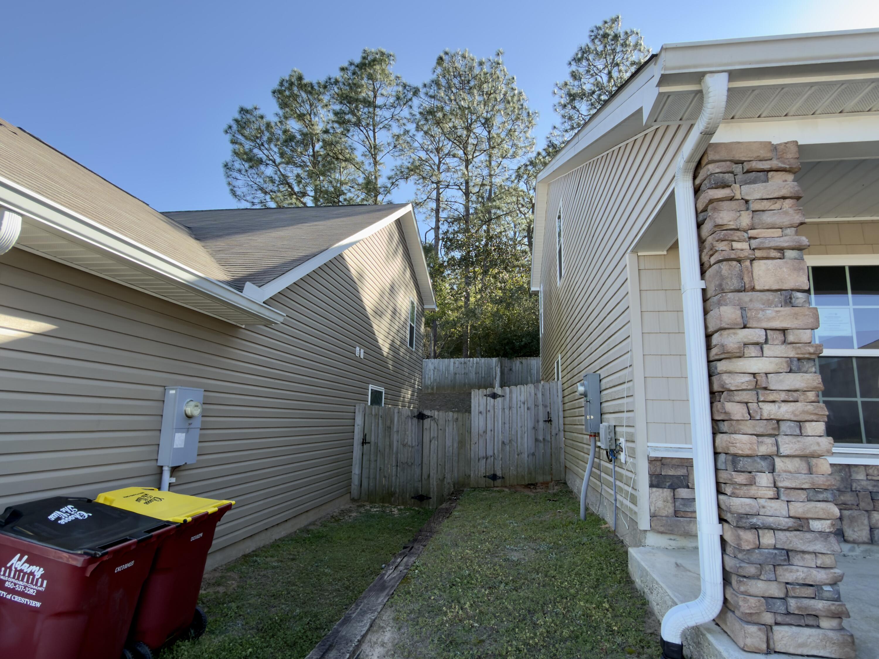 201 Wainwright Drive Crestview, FL 32539 - Photo 23 of 26 a view of a backyard with chairs and iron fence
