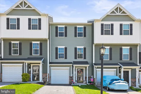 a front view of a residential apartment building with a yard