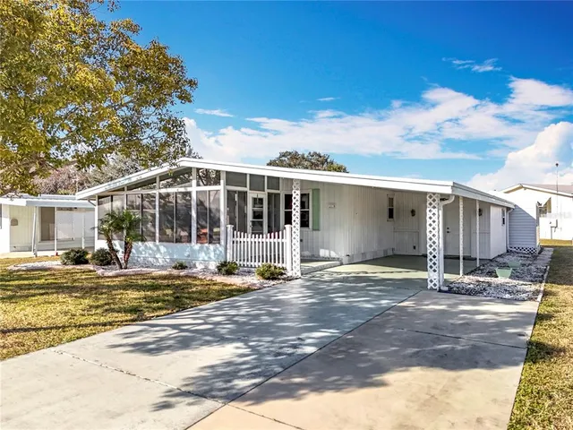 a view of a house with a yard and sitting area