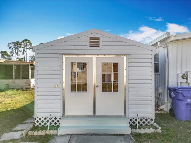an aerial view of a house with a garden and lake view